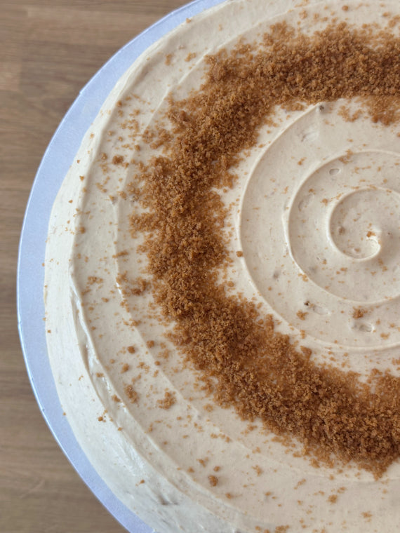 Top-down view of a biscoff pancake cake set on a white stand.