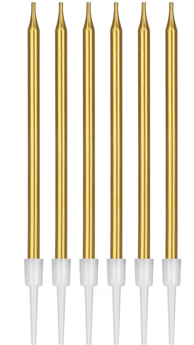 Set of six gold-colored candles with white handles on a white background