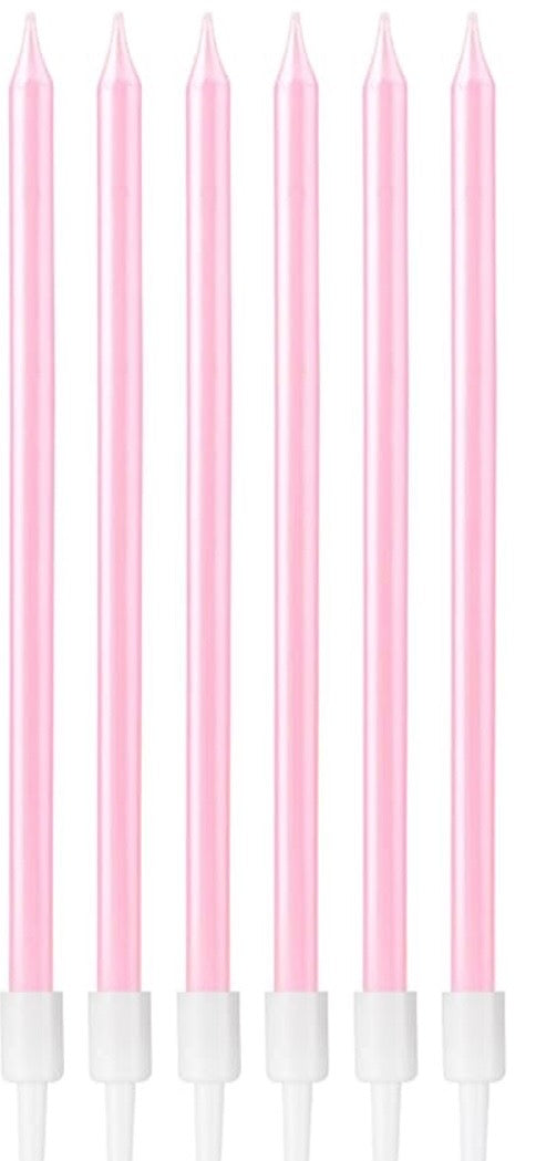 Set of six pink candles with white bases on a white background
