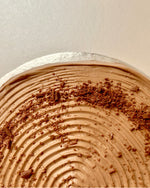 Close-up of a chocolate hazelnut pancake cake set against a white background.